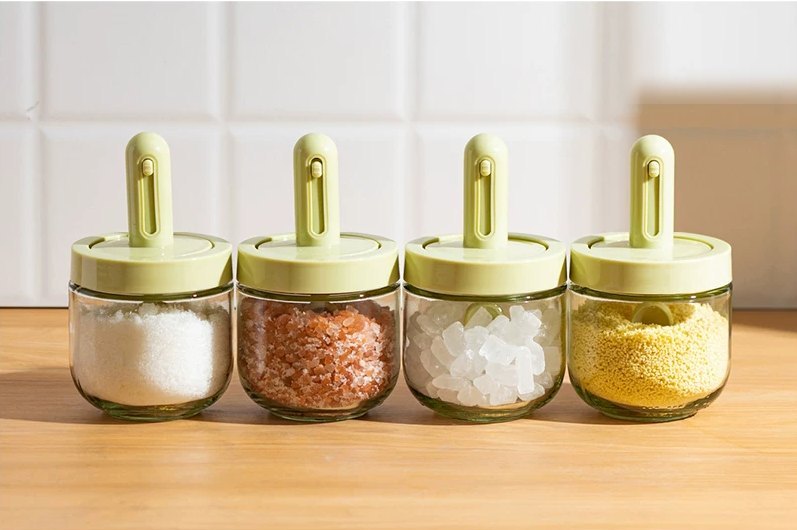 Four Home Date spice jars filled with salt, pink salt, rock sugar and seasoning
