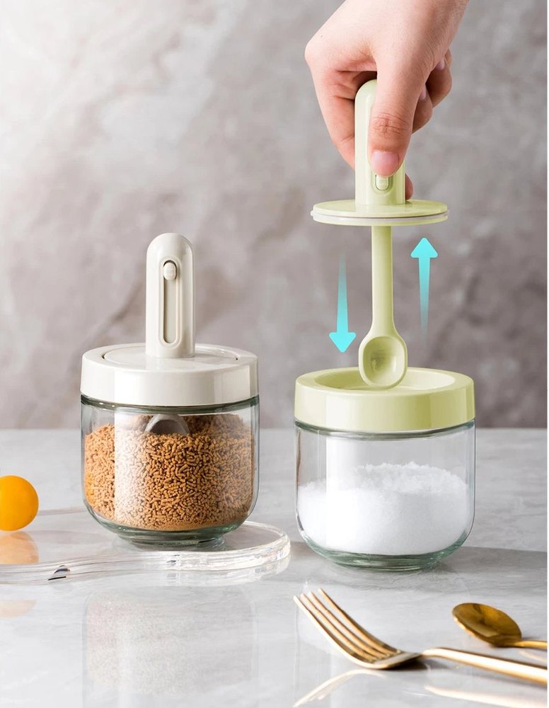 Hand lifting the built-in measuring spoon out of a Home Date spice jar